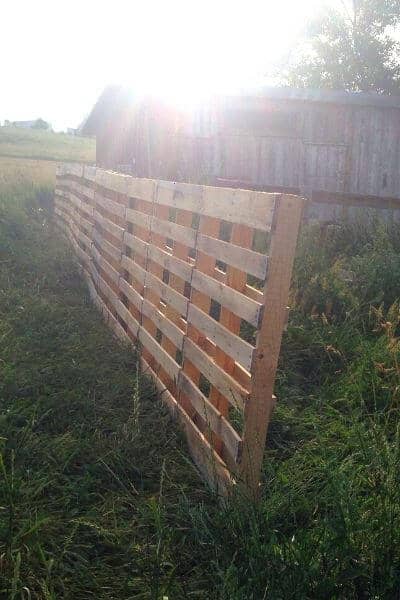 Fence using pallets in the process of being built