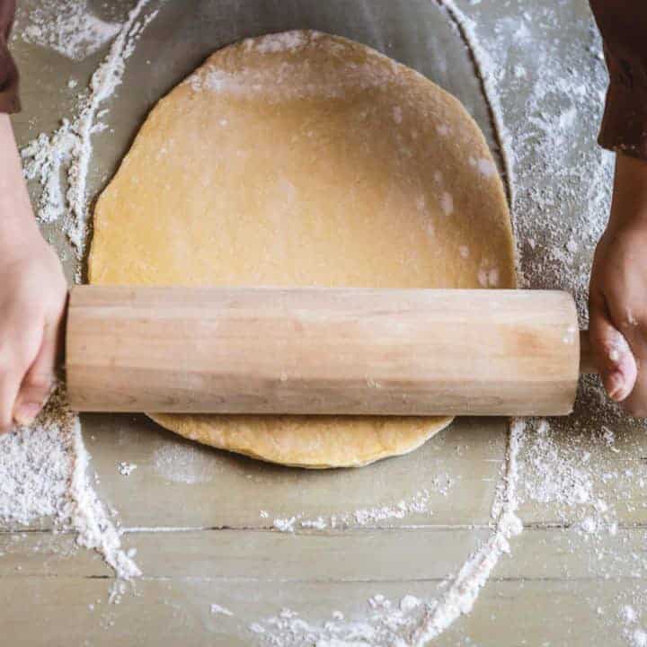 rolling pin rolling out homemade pita bread