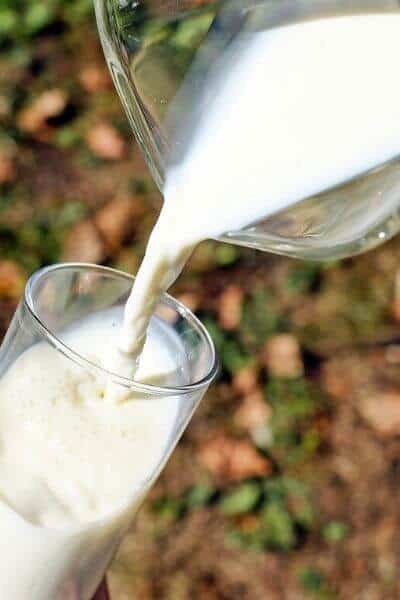 Pouring raw milk into a glass
